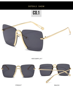 Detail view of oversized rimless sunglasses with gold metal frame and gradient dark lenses