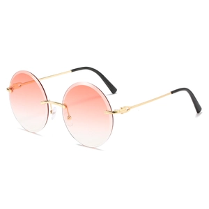 Retro round rimless sunglasses with pink-orange gradient lenses and gold metal frames