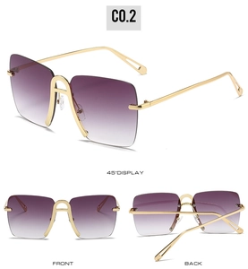 Detail view of large frame gradient purple lenses with gold metal temples on sunglasses