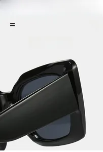 Detail of sleek black square cat-eye sunglasses with lightweight elastic frame finish