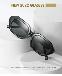 Detail of black geometric sunglasses on minimalist white pedestals with UV protection