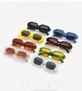 Flat lay of retro geometric sunglasses in eight vibrant colors on a white background
