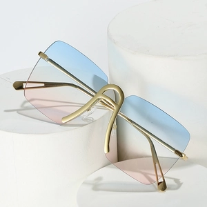 Frameless oversized sunglasses with blue-pink gradient lenses and gold metal frame