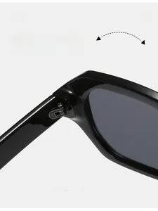 Macro detail of durable silver metal hinge on black oversized polygon sunglasses
