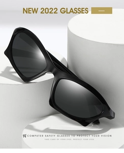Detail shot of black rectangular sunglasses featuring wide temples on geometric display