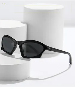 Detail of modern wide-temple black chunky sunglasses on white geometric display stand
