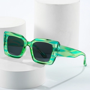 Translucent emerald green cat eye sunglasses with thick frame and dark lenses