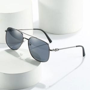 Classic double bridge metal aviator sunglasses with dark grey lenses on white pedestals