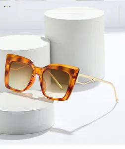 Detail of tortoise shell sunglasses featuring gradient lenses and gold hollow metal temples
