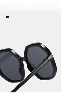 Detail view of lightweight black octagonal sunglasses showing hinge and lens texture