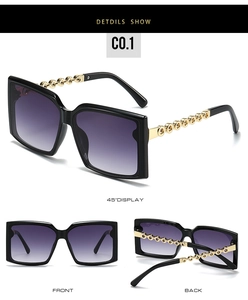 Close-up of square sunglasses with black frames and golden chain link temple detail