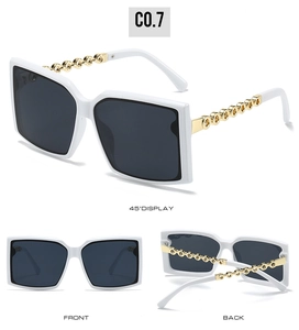 Detail view of square white sunglasses featuring stylish golden chain link temples and dark lens