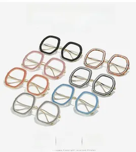 Macro detail of oversized optical frames featuring shimmering glitter texture and metal temples