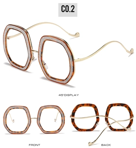 Detailed views of tortoiseshell glasses frames with silver glitter and gold metal temples