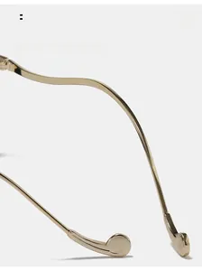 Detail of light gold ergonomic curved metal temple arms for optical glasses frame