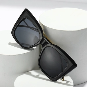 Fashionable oversized cat-eye sunglasses with black frames and dark gray lenses