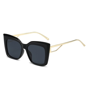 Retro Y2K cat-eye sunglasses with black frame and golden hollow geometric temples