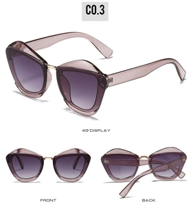 Macro detail of oversized cat-eye sunglasses with purple gradient lenses and gold accents