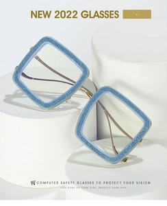 Macro shot of glitter blue oversized square frame with slim gold metal temples