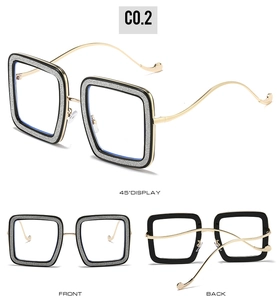 Detailed views of square frame glasses with black outer rims and silver glitter inner detailing