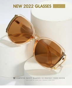 Detail view of large brown frames with premium metal hinges and amber lenses
