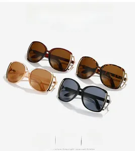 Detail view of four large frame sunglasses in black, tortoise, red and champagne