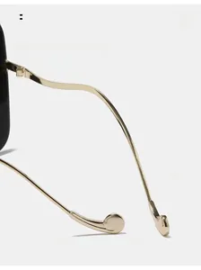 Detailed macro view of curved golden metal mirror legs with rounded ends for comfort