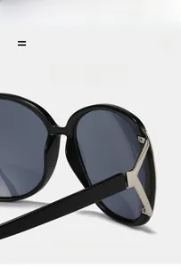 Detail of oversized sunglasses with silver V-shaped hinge and super elastic frame