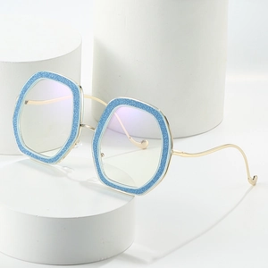 Oversized hexagonal glasses with blue glitter frames and wavy gold metal temples