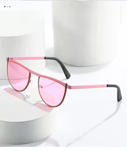 Detailed view of pink geometric sunglasses on white minimalist display pedestals
