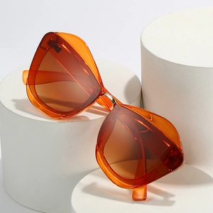 Modern orange cat-eye sunglasses with translucent geometric frame and gold metal bridge