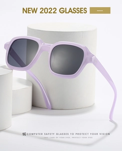 Detail of lavender square sunglasses with dark lenses on white cylindrical pedestals