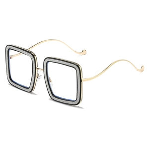 Fashionable oversized square glasses with golden wavy temples and black glitter frame
