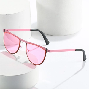 Modern geometric sunglasses with pink metal frames and translucent lenses on stone base