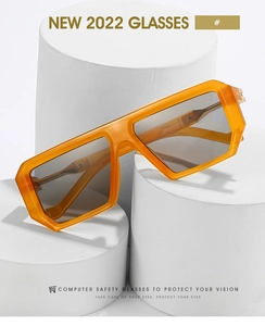 Detail of square orange geometric frames with light grey lenses on a white display