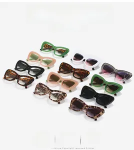 Multiple stylish cat-eye sunglasses in various colors and patterns on white background
