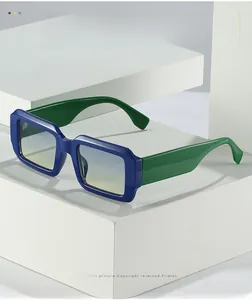 Détail des lunettes de soleil carrées bleu et vert sur des blocs de présentation blancs