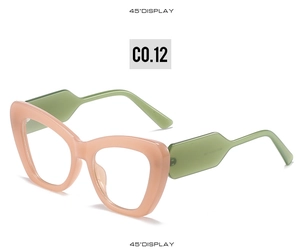 Detail of cat eye glasses frame in peach pink and mint green color contrast at 45 degree angle