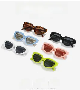 Flat lay of Y2K cat eye sunglasses in various colors including tortoiseshell and yellow
