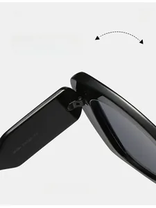 Detailed macro view of durable reinforced metal hinge on black cat-eye sunglasses