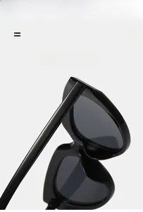 Detail shot of sturdy hinges on black heart-shaped Y2K sunglasses with polished texture