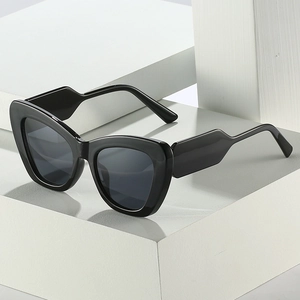 Fashionable oversized black cat eye sunglasses with thick frames and dark gray lenses