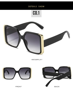 Detail view of large square sunglasses featuring thick black temples and gold metal accents