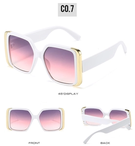 Macro view of white square sunglasses with gold metal trim and gradient purple pink lenses
