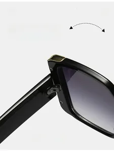 Close-up of durable metal hinge on black square oversized sunglasses with gradient lenses
