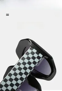 Detail show of oversized sunglasses featuring black frames and checkered pattern temples