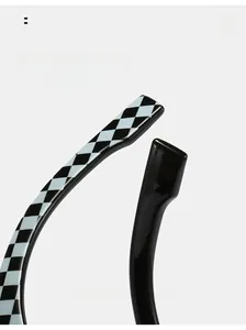 Detail of ergonomic curved temple tips with black and white checkered pattern and glossy finish