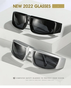 Detail of black and silver wraparound sports sunglasses on a geometric display stand