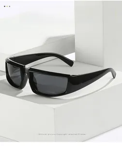 Detail shot of black oversized square sunglasses with thick glossy frames and dark grey lenses