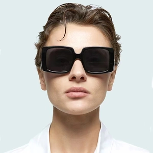 Front view of model wearing chic square black oversized sunglasses with thick frames